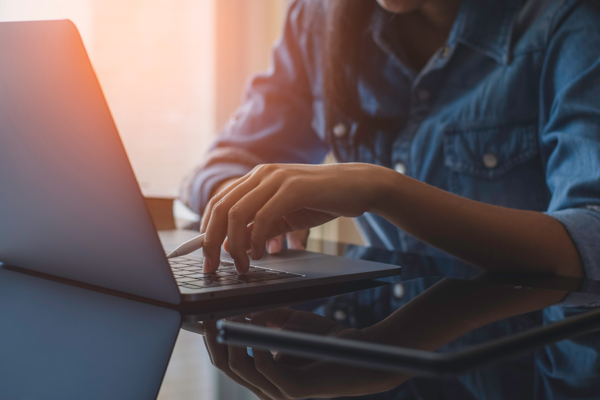 Woman with biros on laptop.