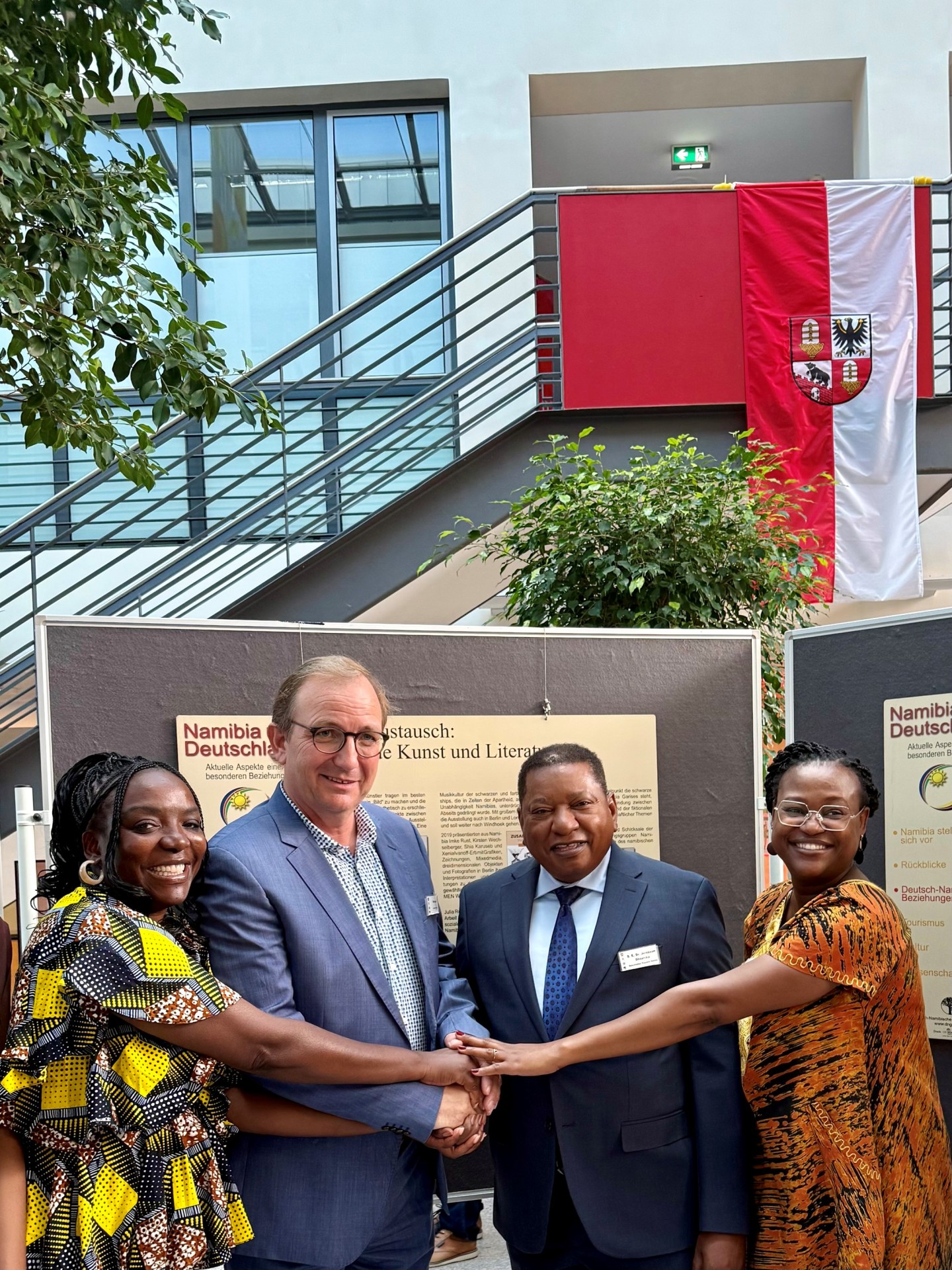 The photograph shows (from left) Naita Hishoono, District Administrator Markus Bauer, Ambassador Jerobeam Shaanika and Ndilimeke Auala-Weidner.